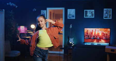 Young girl getting tons of engagement on her dancing clips posts on social network platforms. Happy internet star child filming viral videos, impressing audiences with dance movesの写真素材