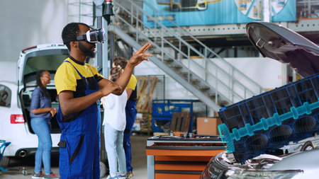 Repairman in car service using advanced virtual reality technology to visualize engine turbine in order to fix it. Knowledgeable garage specialist wearing vr glasses while servicing defective vehicleの写真素材
