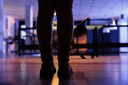 Selective focus of businesswoman leaving startup office late at night after working overtime at financial investment strategy. Executive manager finishing work program. Corporate conceptの写真素材