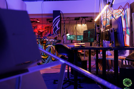 Ransomware on computer screen stealing privacy information in abandoned warehouse at night. Malicious software on monitors cracking password and breaching data in room with nobodyの写真素材