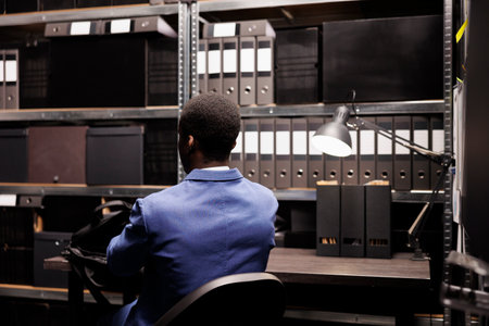 Federal agent checking surveillance evidence, discovery new investigation information about mysterious crime. Private detective working late at night in police station. Law enforcement conceptの写真素材
