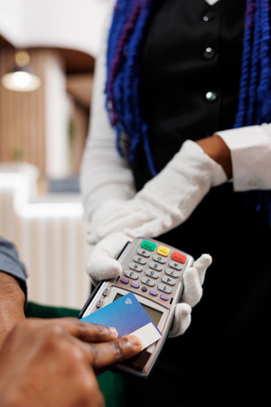 Man making payment using contactless credit card, closeup of hand paying bill order with NFC...