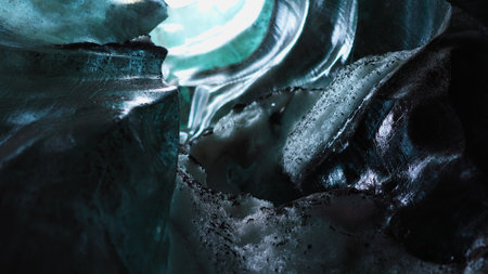 Blue ice blocks inside crevasse with covered frost in iceland, vatnajokull glacier mass with crashed transparent icy rocks. Frozen wintry ice caves in scandinavian landscape. Handheld shot.の写真素材