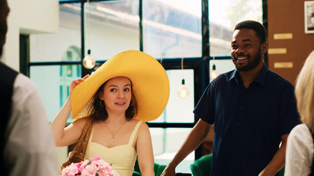 Hotel guests arriving at exotic seaside resort, travelling on honeymoon holiday trip. Diverse couple asking receptionist about check in registration procedure, luxury tropical service.の写真素材