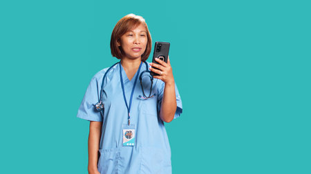 Happy nurse in videocall meeting over the phone, greeting people. Cheerful healthcare specialist in...