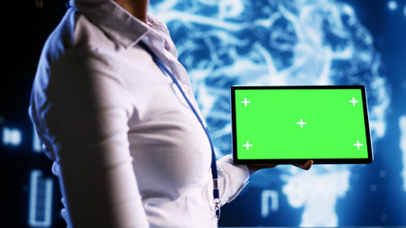 Admin in data center with chroma key tablet using artificial intelligence computing simulating human brain thought processes. African american expert working with AI neural network algorithmsの写真素材