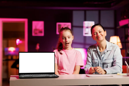 Little girl and her mother filming sponsored content, unboxing newly released mockup laptop to make...