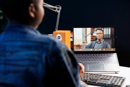 African American woman, having discussion during an online meeting on digital laptop. Female...
