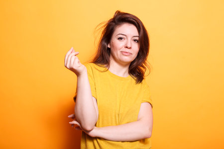 Confident female adult with brunette hair and a happy smile. She stands, looking at the camera,...