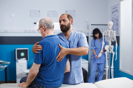 Retired patient receives chiropractic care for back discomfort in order to heal physically. Nurse...