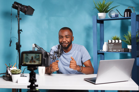 Smiling blogger using camera for recording video and creating digital content for online blog....
