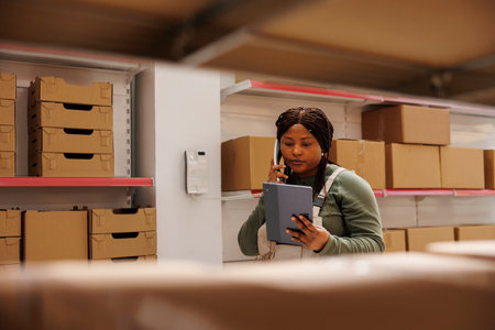 African american supervisor having remote conversation with manager discussing shipping details in...
