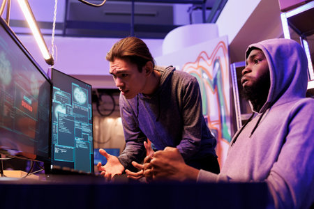 Frustrated criminals failing while attempting to crack strong password. Scammers breaking into network system unsuccessfully looking at screen displaying access denied messageの写真素材