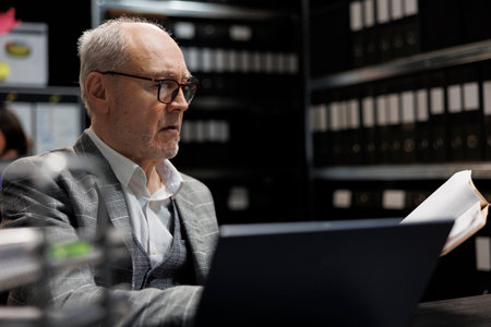 Accountancy businessman checking bookkeeping analytical data paperwork. Administration employee in business company file cabinet repository filled with flowcharts and foldersの写真素材