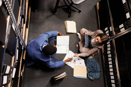 Top view of diverse inspectors working at fraude cause, analyzing company evidence trying to catch...