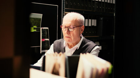 Experienced law agent on phone call talking to criminal expert about forensic evidence results, trying to uncover new case clues. Private investigator calling criminologist to do background check.の写真素材