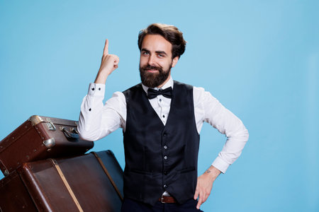 Doorkeeper coming up with new idea, finding solution in studio with background. Hotel concierge employee in suit being genius and thinking about answer to solve problem on camera.の写真素材