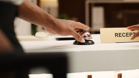 Business trip guests ready to book in their reservation at hotel lobby reception counter. African...