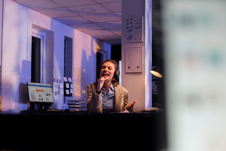 Executive manager with headphones listening music and having fun, working overtime at marketing...