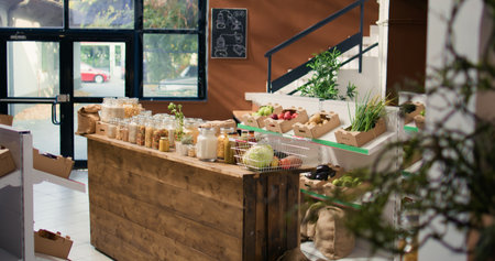 Bulk products in reusable glass jars used by zero waste small business store to lower climate impact and support sustainable lifestyle. Local supermarket with pantry supplies.の写真素材