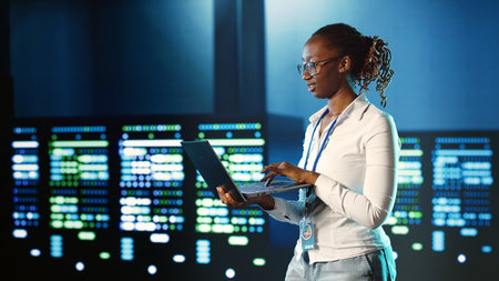 Hardworking IT practitioner strolling through server rows providing processing resources for...
