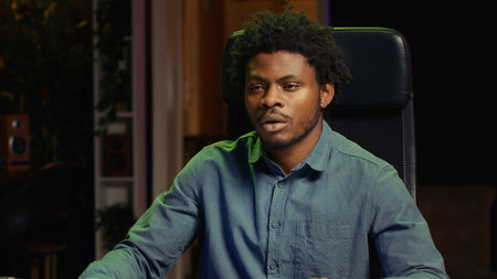 BIPOC player discussing with audience while playing videogames during livestream. Gaming media star chatting with viewers, presenting ways of being victorious in esports tournamentsの写真素材