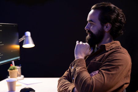 Happy computer engineer satisfied after futureproofing company network from downtimes and unexpected system failures. Smiling IT admin pleased after managing to increase data securityの写真素材