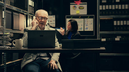 Private investigator requesting crucial information on landline phone call, reaching out to colleagues to find specific evidence relevant to crime case. Detective asks for assistance. Camera B.の写真素材