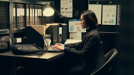 Detective uses forensic techniques to examine evidence stored in the archive, browsing through old classified documents to uncover clues. Private inspector studying classified information. Camera B.の写真素材