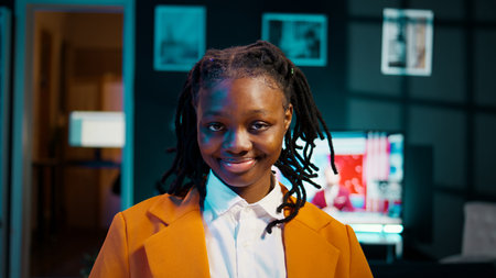 Portrait of university student participating in e learning courses, reviewing lesson materials and lecture notes at home office. Dedicated girl writing ideas for future exams or tests. Camera B.の写真素材