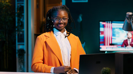 Portrait of university student sitting at her home desk using laptop to do school tasks. Young woman exploring career pathways and networking opportunities through professional platforms. Camera A.の写真素材