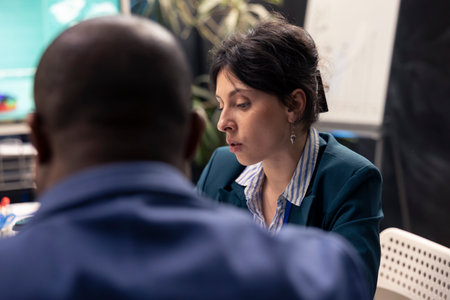 Sales representative team evaluate financial plans and success metrics with archived data info, looking for business expansion opportunities. Training to increase capital funds for company.の写真素材