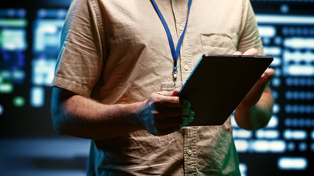Close up of specialist in high tech facility providing secure, scalable, and reliable infrastructure for storing, processing, and analyzing large amounts of data generated by artificial intelligenceの写真素材