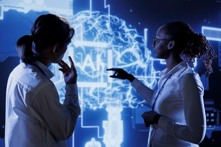 Certified engineers brainstorm ways to use AI cognitive computing to extract usable information from complex data. Teamworking experts implement artificial intelligence to process massive datasetsの写真素材