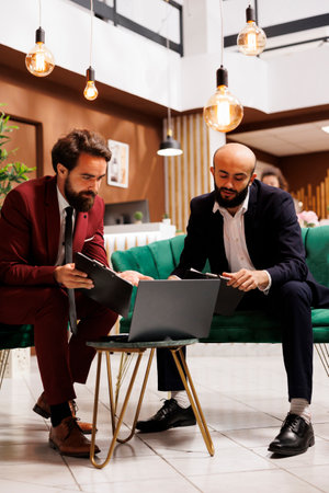 Coworkers collaborating at meeting, sharing diverse expertise to drive project forward for growth. Business partners engaging in discussions, strategizing ideas for the future, conference table.の写真素材
