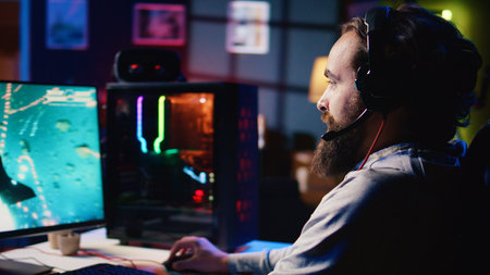 Happy man using headphones to play spaceship flying singleplayer game with overlay HUD showing...