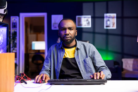 Gamer struggling to defeat opponents while playing esports tournament, unhappy with his performance. Upset player losing while competing in multiplayer videogame, showing frustrationの写真素材