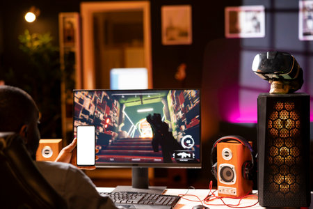 Isolated screen smartphone held by player competing in online multiplayer videogame at home. Mockup...