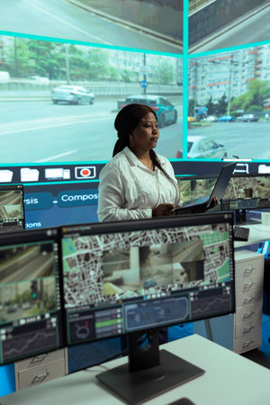 African american leader reviewing traffic data collected from video surveillance, instructing her...