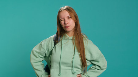 Young actress goofing around, switching emotions, trying different facial expressions, practicing for theatre class, studio background. Teenage woman making silly faces, camera Aの写真素材