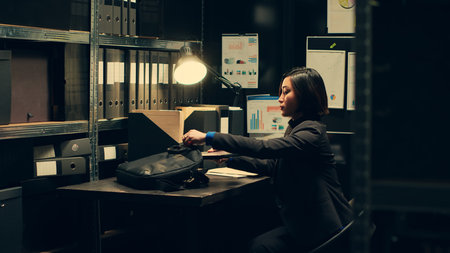 Private agent initiates background checks on individuals associated with archived cases to gather relevant information. After reading legal statements, leaving for field work. Camera A.の写真素材