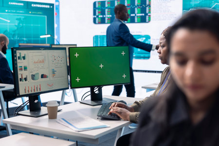 Focused team leader calculating monthly budget balance in office, using an isolated mockup screen on...