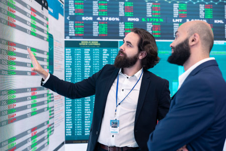 General director discussing with an investor to increase funding for a project, presenting performance metrics and annual data on a big screen. Business associates share strategies.の写真素材