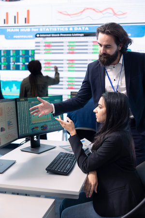 Diverse business analysts working together to evaluate costs and create a projection to deduct the future enterprise situation. Financial advisers specialists studying budget numbers.の写真素材