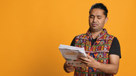 Irked manager looking over company financial profit report audit, disappointed by results, isolated over studio background. Mad indian man throwing business documents in frustration, camera Aの写真素材