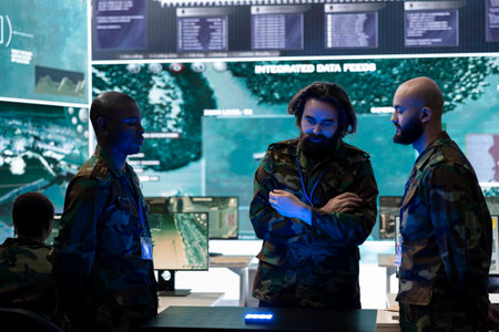 Diverse soldiers analyzing satellite images on a 3d hologram to discuss operations plan in command post, operating with high tech gear. Recruits using 3d projection for new defense mission.の写真素材