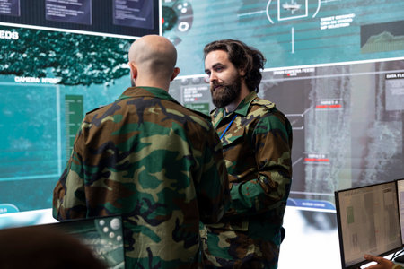 Reconnaissance department specialists gathering information for a national safety mission, transmitting intelligence to the infantry unit. Telecommunications staff in army command center.の写真素材
