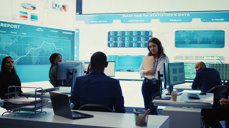 Executive consultant gathers his staff to discuss about performance metrics, looking for ways to...