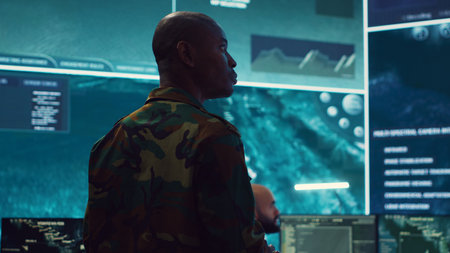 General of the army overseeing special reconnaissance mission in control center, undertake intelligence gathering operations with CCTV footage and a world map on a big screen. Camera A.の写真素材