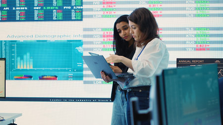 Coworkers team analyzing infographics to provide solutions on an issue affecting the project, looking to finish tasks before deadline. Business employees working together to ensure progress. Camera A.の写真素材